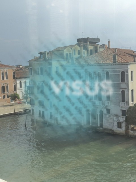 Venice old buildings near a canal with water sunny day full view