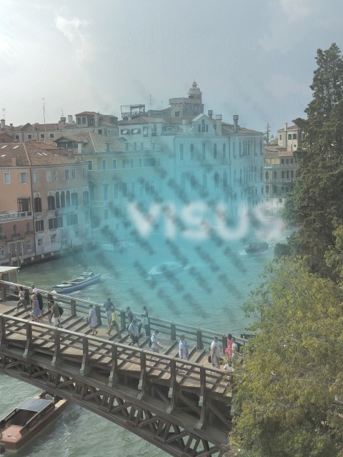 Italian venice bridge with people and boats passing by old buidings