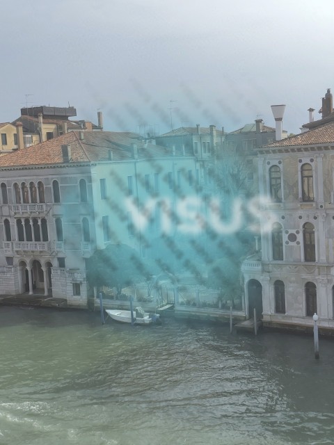 Old Venetian palaces with trees canal entrance and boat