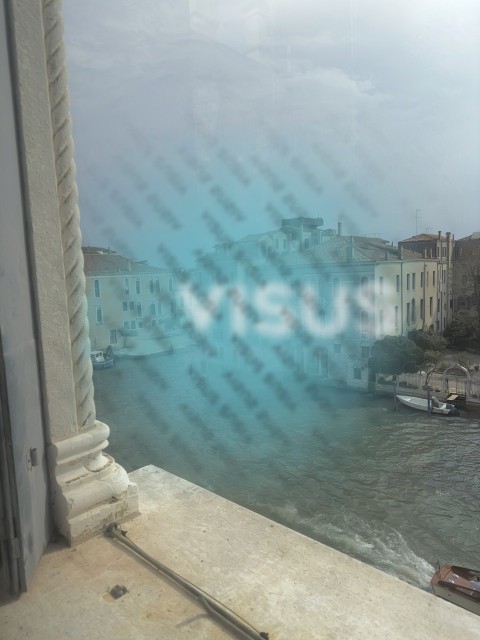 Ancient palaces of venice seen through a window on the grand canal