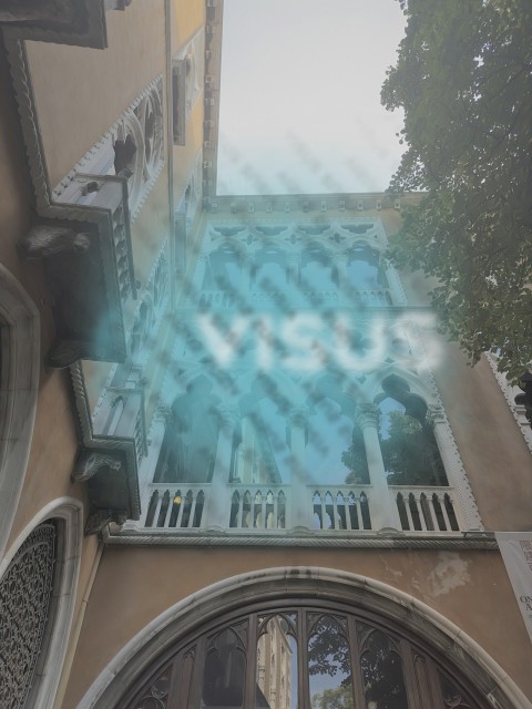 building with antique Venetian-style windows in white marble view from below with mansion tree